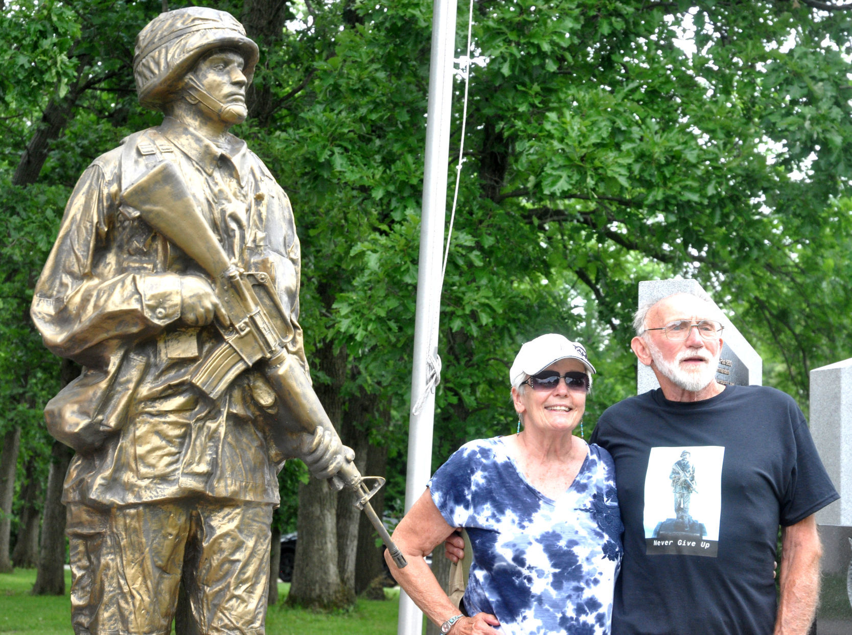 Darlene Olenoski and Richard Olenoski of the village of Bloomfield stand next to a military